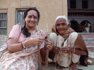 Grandmother  holding the Tulsi mala which she makes